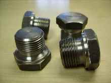 Machined header plugs